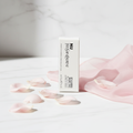 YSL NU Lip and Cheek Balmy Tint Nu Pinch on white marble with rose petals and pink silk, elegant beauty photography