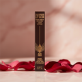 Charlotte Tilbury Airbrush Flawless Lip Blur Walk of No Shame on pink marble with rose petals and golden light