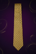 YSL yellow silk tie with calla lily print – front view on purple velvet