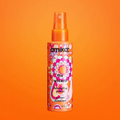 Amika The Wizard Detangling Primer small orange spray bottle on orange background