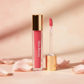 Rare Beauty Soft Pinch Tinted Lip Oil pink shade on blush background with rose petals and golden light
