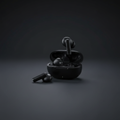 Fisher Vibez Sound black true wireless earphones and charging case on dark slate surface with studio lighting